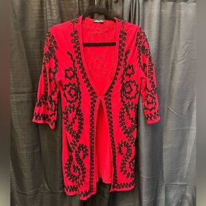 Red kimono with black embroidered trim